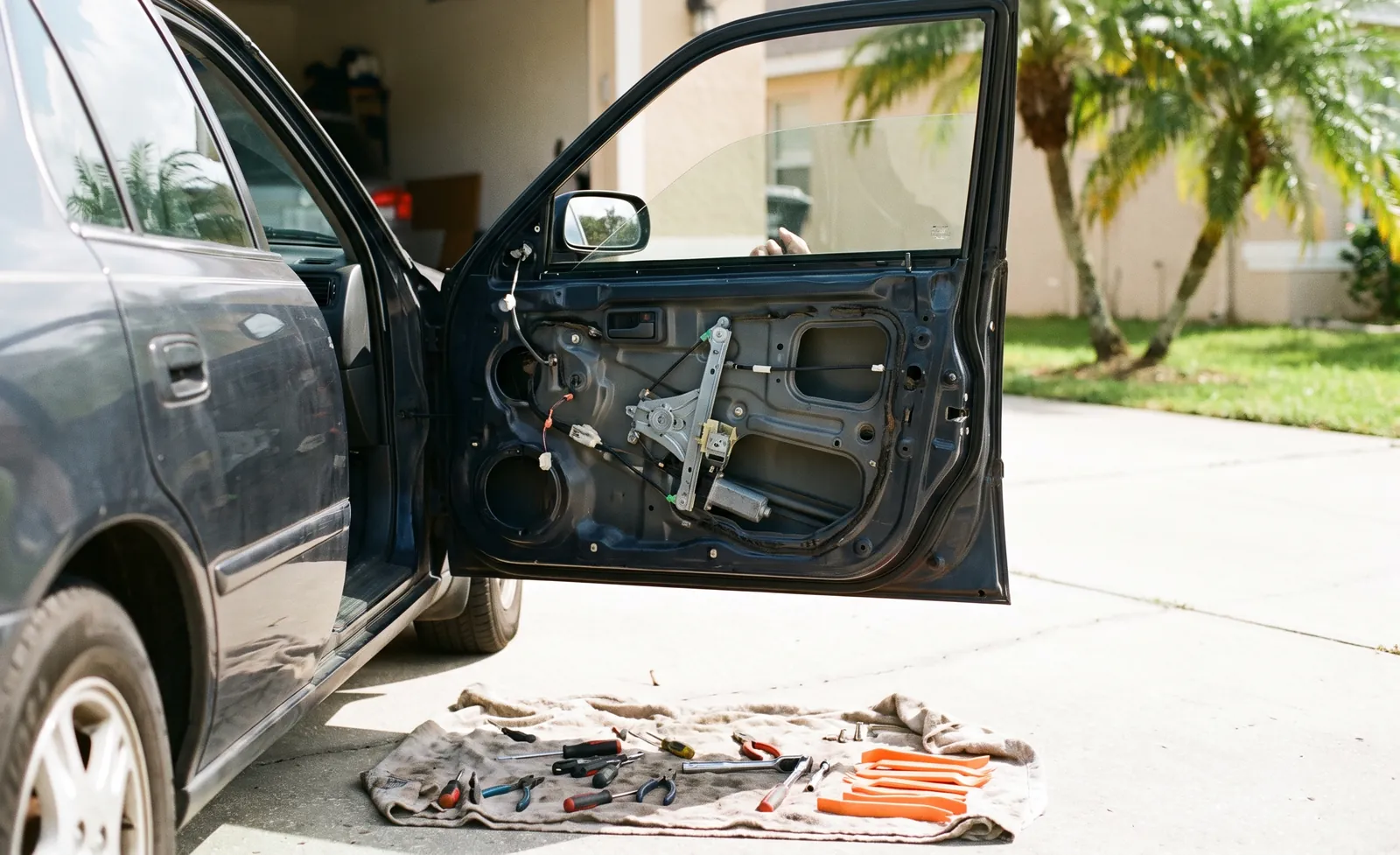Car door with the panel removed showing the window regulator
